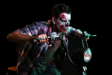 Fototapeta na wymiar Man dressed for Halloween as zombie with motorcycle on dark background