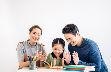 Portrait enjoy happy love asian family father and mother with little asian girl learn and study on table.Mom and dad with asian young girl writing with book and pencil in homeschool at home.Education