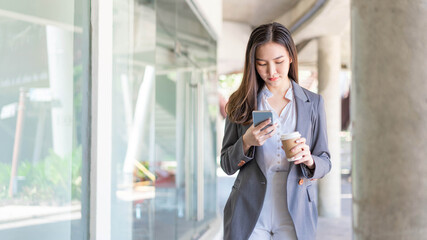 Fototapeta premium Working woman concept a young female manager attending video conference and holding a cup of coffee