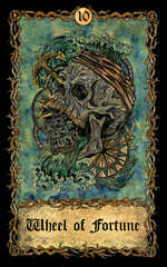 Wheel of Fortune. Major Arcana tarot card with skull over antique background.