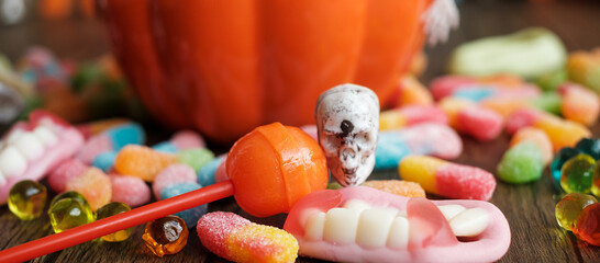 Happy Halloween day with ghost candies, pumpkin bowl, Jack O lantern and decorative (selective...