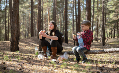 Fototapeta premium son and mother eating in the woods