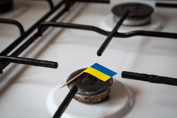 Natural gas exports and imports. High price. Ukrainian flag on gas stove