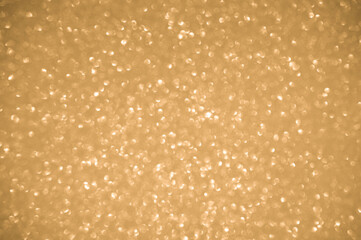 Gold glitters background. shimmering blur spot lights Bokeh Shiny gold light background.