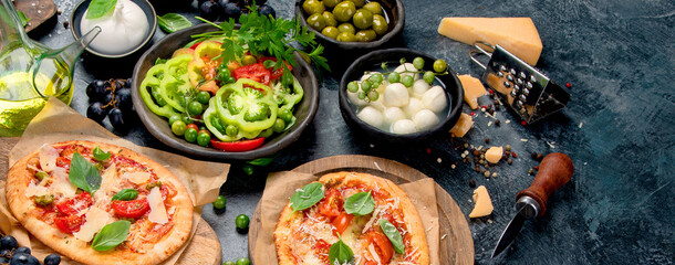 Italian food assortment on dark background.