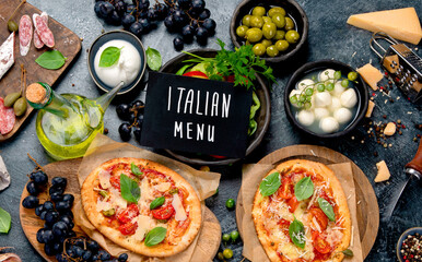 Italian food assortment on dark background.