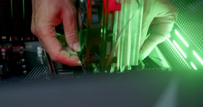Hands of a young male technician building a new pc
