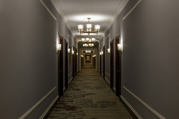 Empty luxurious hotel corridor lit by chandeliers in San Francisco, CA