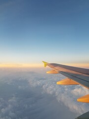 Airplane wing in blue sky