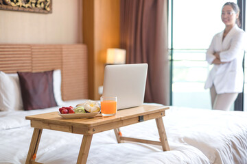 Focus on fruit. Asian businesswoman exhausted from business trips, ready to receive fruit snacks from the hotel, arrange a service for VIP guests