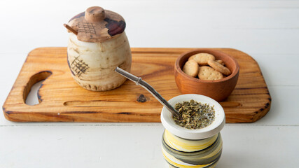 Close view of a yerba mate hot infusion opn top of a white table