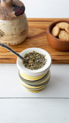 Close view of a yerba mate hot infusion opn top of a white table