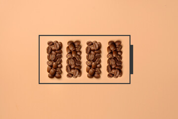 Coffee beans in the form of a charged battery. A symbol of an energetic start to the day