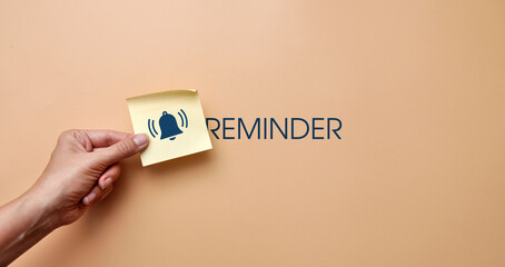 A sticker with drawings of a bell and the inscription: "Reminder". Reminder symbol