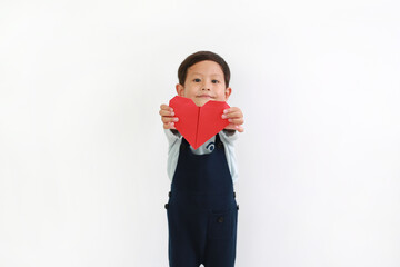 Portrait of Asian little baby boy giving red heart sign for you against white background. Focus at red heart in hands