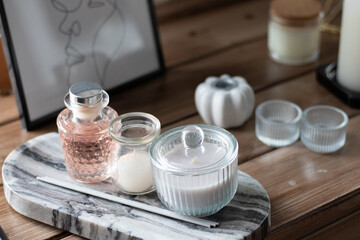candles and perfume are on the table