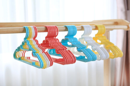 Colored plastic Clothes Hangers on wooden clothes line