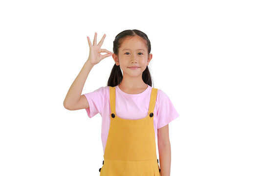 Portrait of smiling Asian little girl with hand hanging something blank isolated on white background.