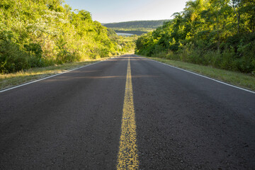 Freedom. View of the asphalt road across the green tropical rainforest. 