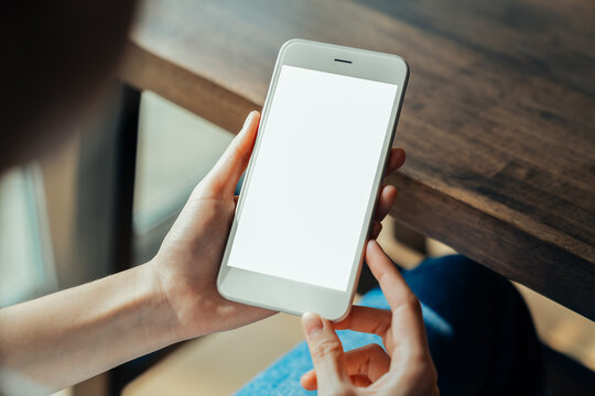 Woman hand holding smartphone and the screen is blank, social network concept, copy space for your advertising..