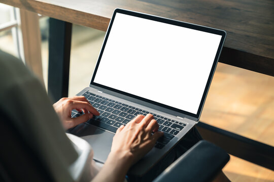 Woman using laptop with blank copy space screen for your advertisement. on the table in office.