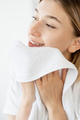 Face wash. Morning hygiene. Cleansing care. Pretty smiling woman drying smooth perfect skin after...