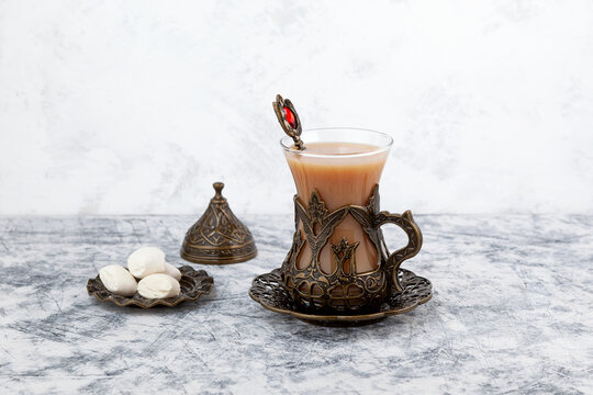 Adrak tea or Masala chai. Indian ginger tea with milk and spices on grey background
