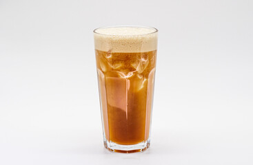 Iced coffee with milk and ice cube isolated white background.