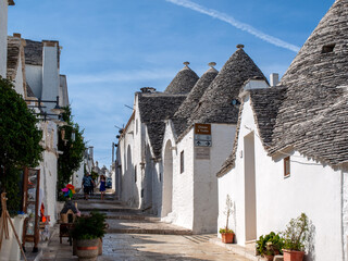 People visit Trulli village in Alberobello, Italy. The style of construction is specific to the...