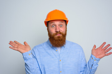 Isolated unsure architect with beard and orange helmet