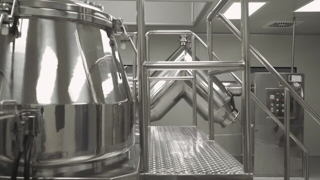 Production of medicines and tablets, view of a special chrome plated mixer tank for mixing powder mixture preparation and medicinal ingredients, the process of rotation.