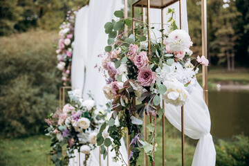 Decorating the arch with flowers and fabric for a wedding ceremony in nature - 460750306