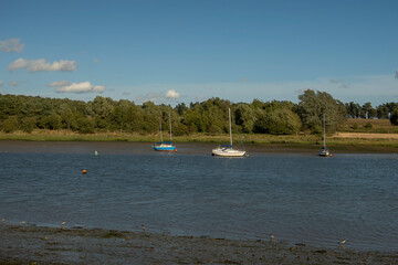 Fototapeta na wymiar Boats on the River Deben at Woodbridge in Suffolk, UK