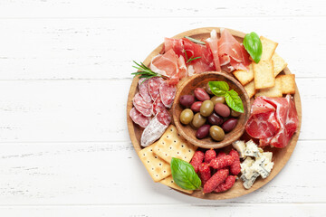 Antipasto board with prosciutto, salami, crackers, cheese, olives