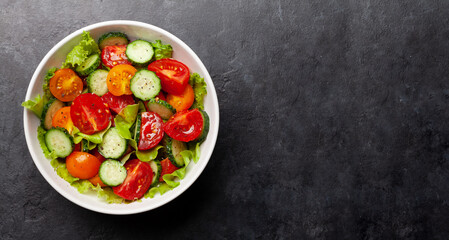 Fototapeta na wymiar Fresh salad with tomato and cucumber