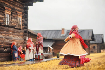 Traditional Slavic rituals in the rustic style. Outdoor in summer. Slavic village farm. Peasants in elegant robes.