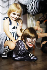 Plakat happy family with childrens in costumes and makeup on a celebration of Halloween