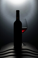 Bottle and glass of red wine.