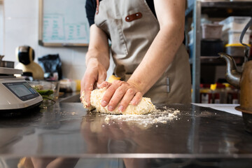 Girl baker forms bread on the table