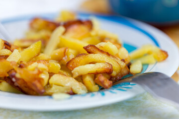 French fries on plate and fork, little left