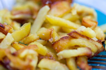 French fries on plate and fork, little left