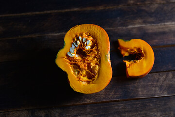 orange pumpkin in a cut on a wooden table