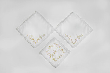 White embroidered wedding towels on a white background.