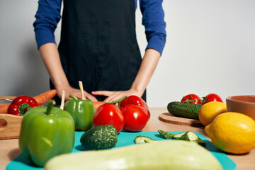 Cook on the kitchen cutting vegetables diet