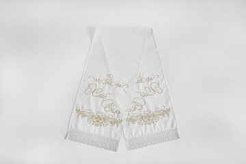 White embroidered wedding towels on a white background.
