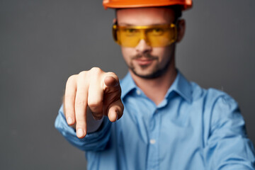 man wearing yellow glasses with orange paint safety work service