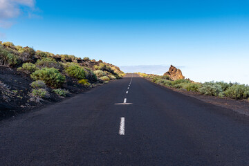 Empty road in a volcanic landscape in the Island of La Palma, one of the Canary Islands, in the Cumbre Vieja volcano area near Teneguia volcano