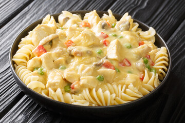 Tasty American Chicken a la King with pasta in the plate on the table. Horizontal