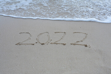Written 2022 on the beach sand with soft wave.