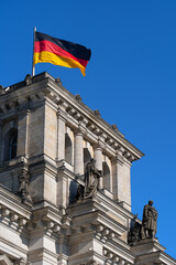 Fototapeta na wymiar Reichstag And Flag Of Germany